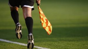 Picture of ref holding a flag